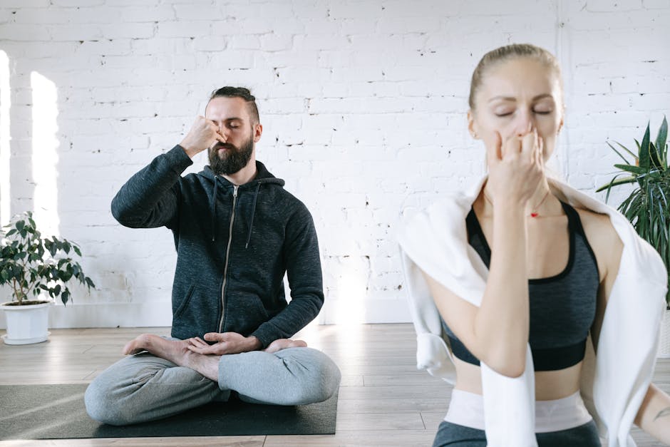 Woman practicing a peaceful yoga pose in a bright living room at home.